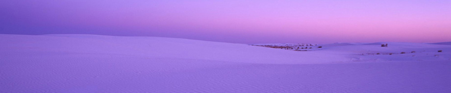 Snowy field with a pinkish purple horizon